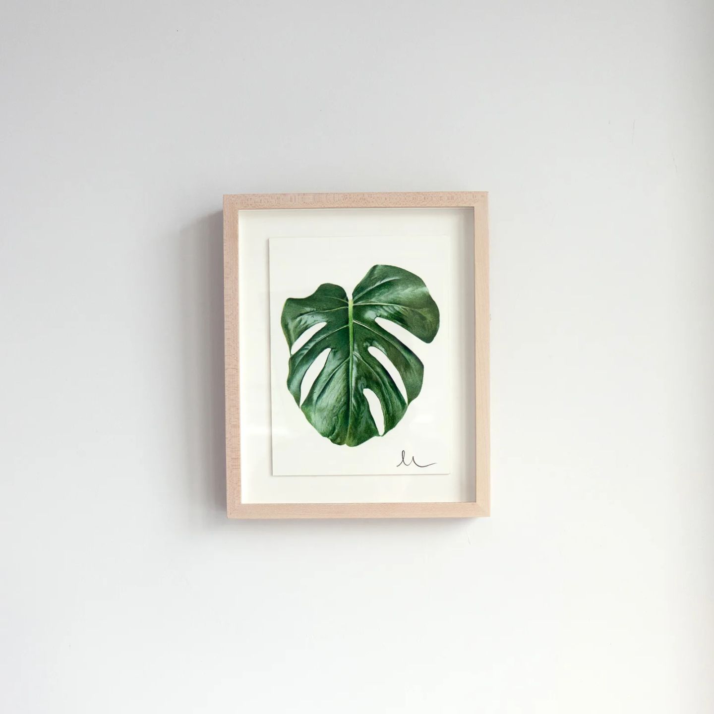A framed Print Club print displayed on the wall