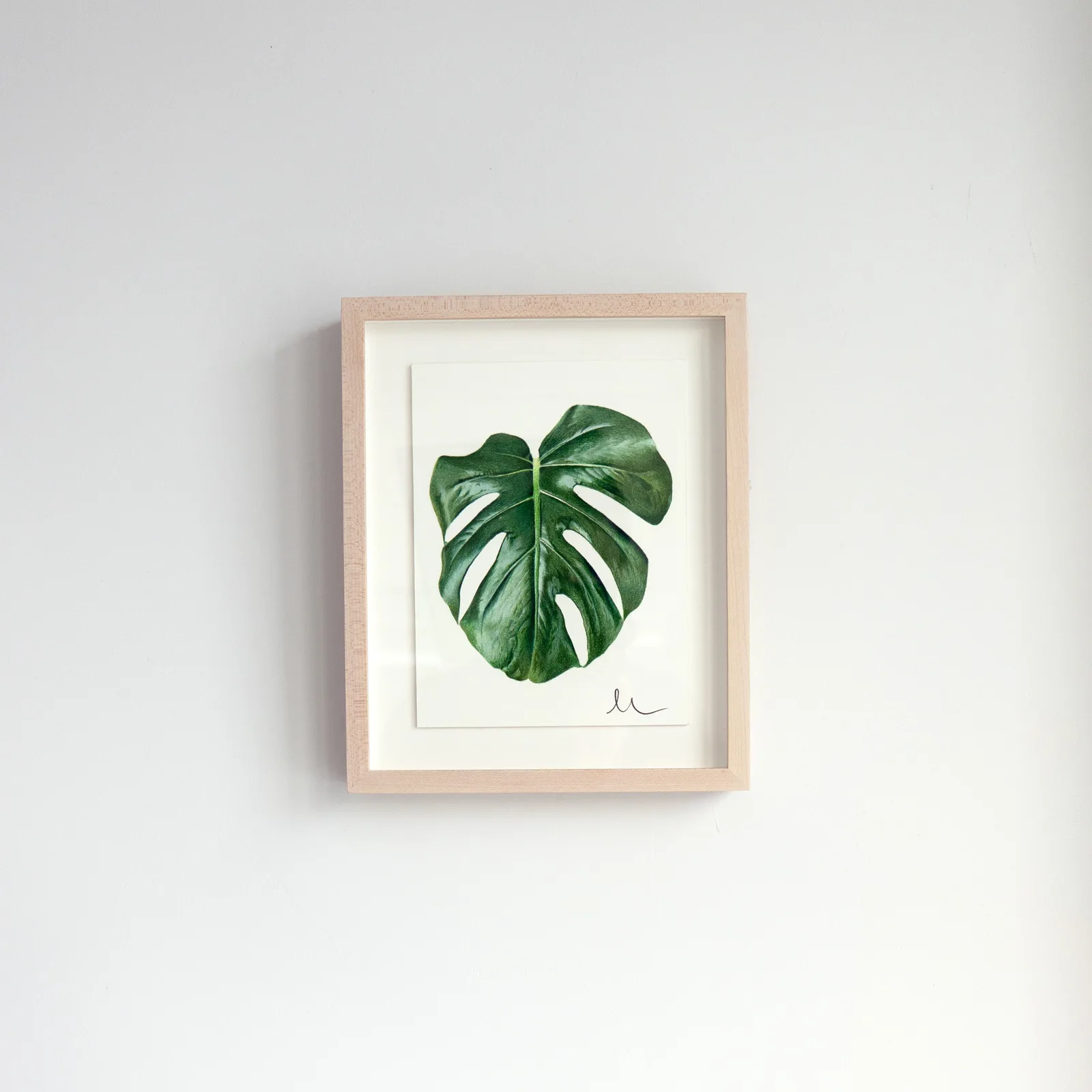 A framed Print Club print displayed on the wall